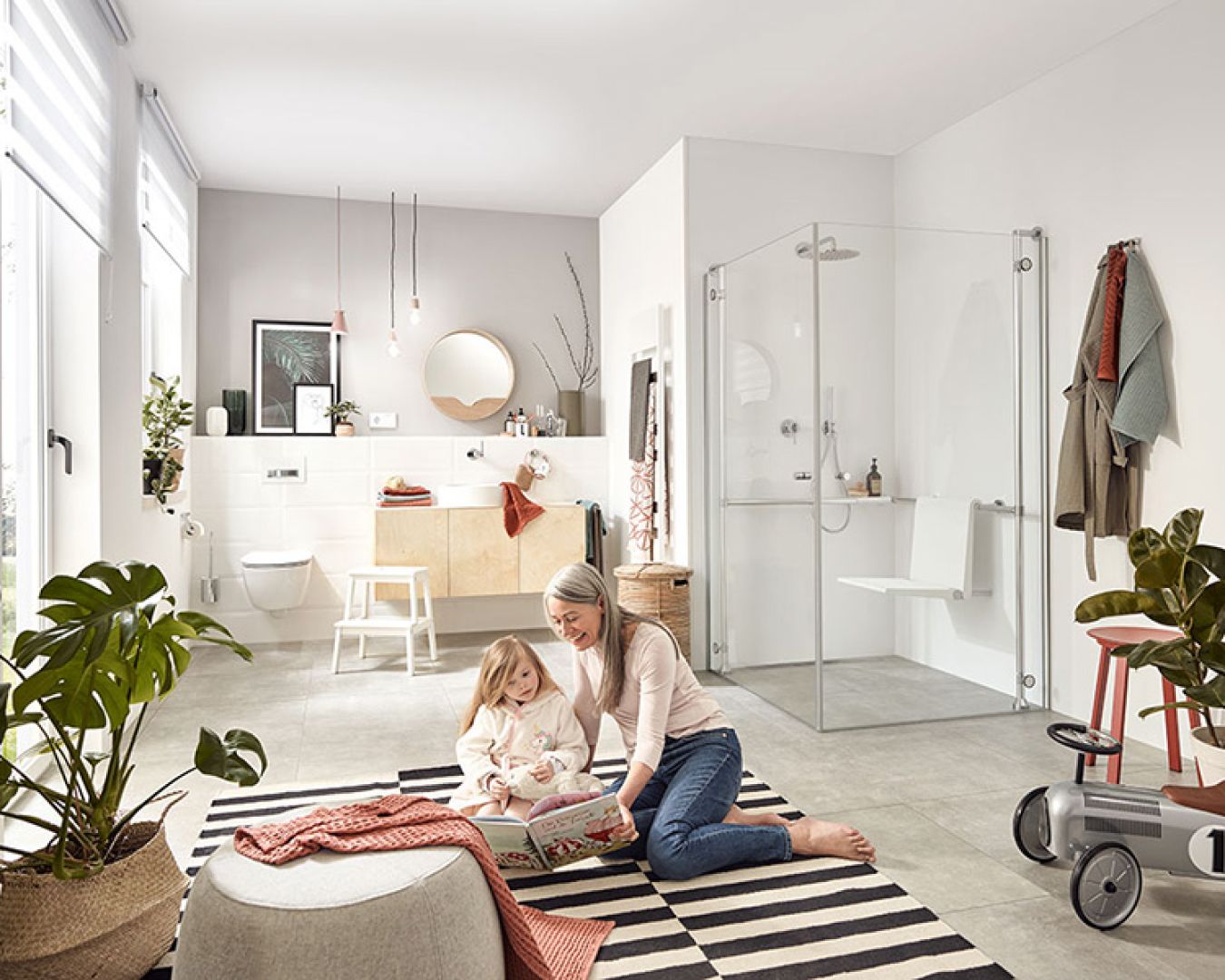 Familienfreundliches Bad mit barrierefreier Dusche und spielendem Kind auf Teppich.