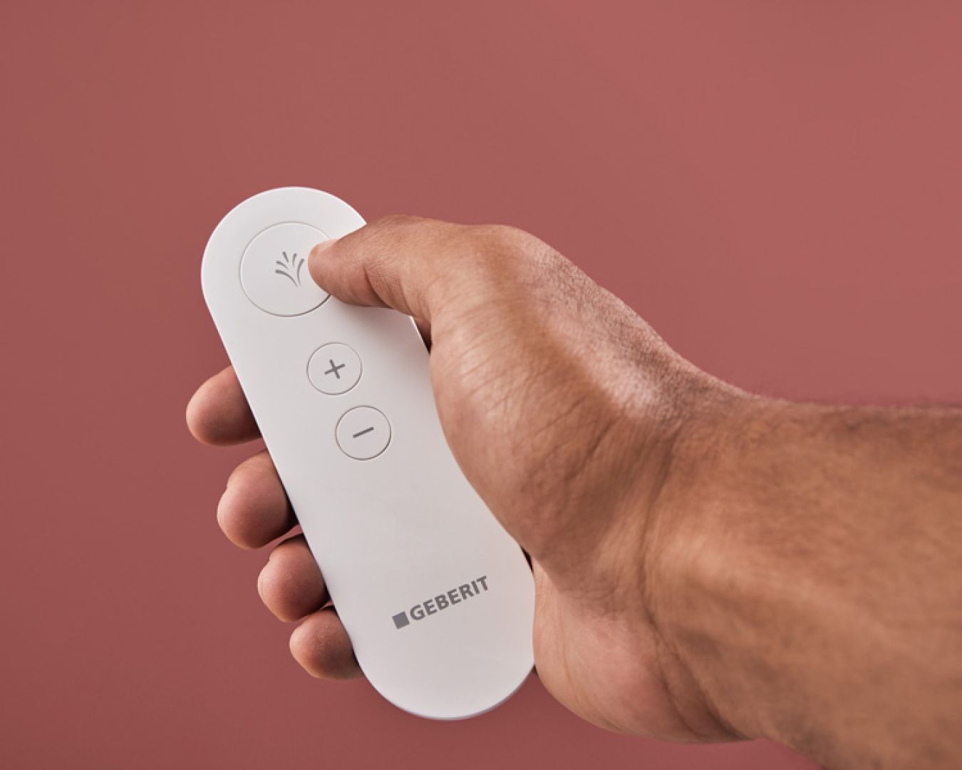 Geberit-Fernbedienung für Dusch-WC mit Sprühfunktion und Plus/Minus-Tasten.

